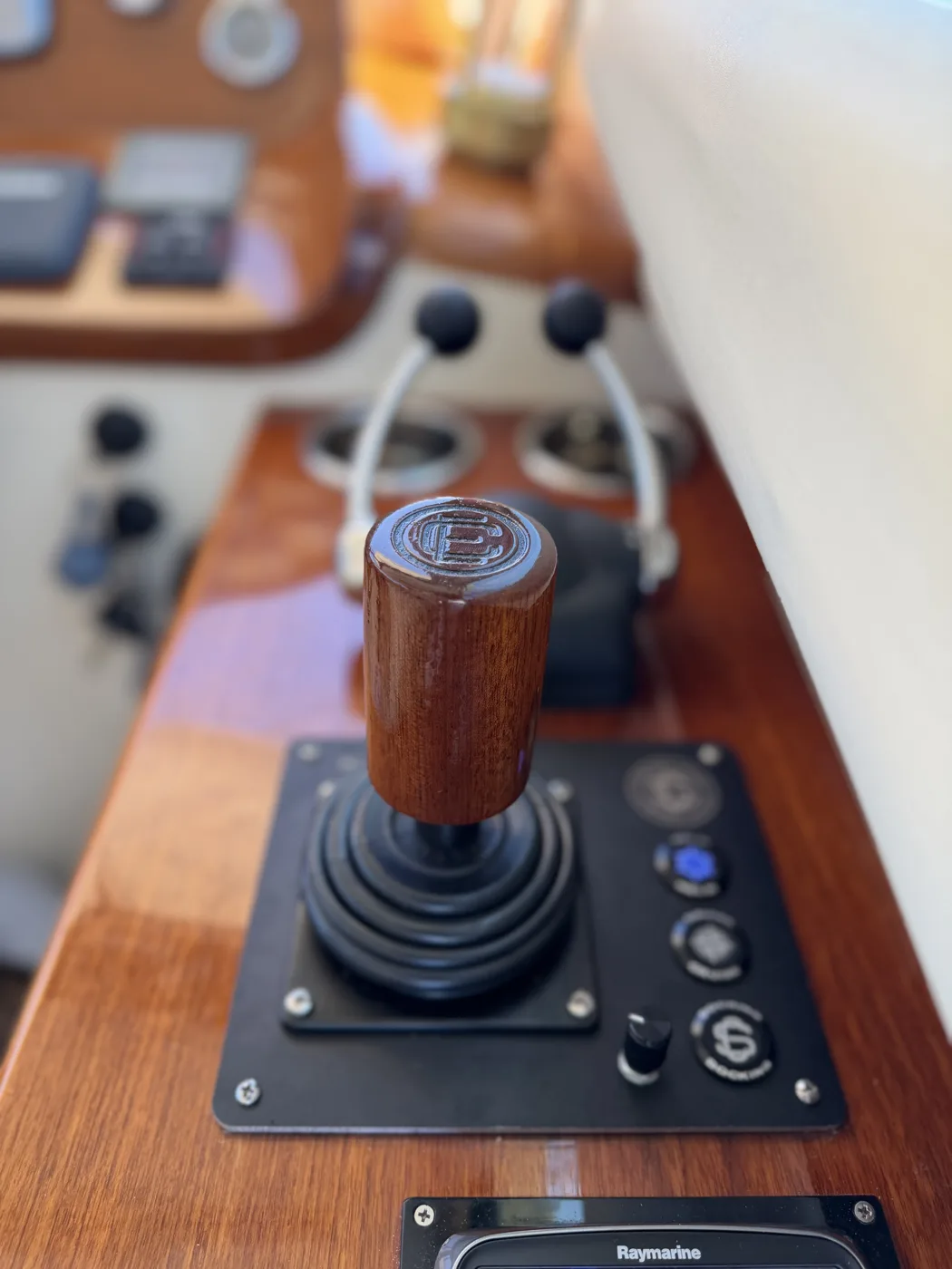 Hamilton Jet joystick control mounted in a varnished teak helm
